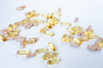 Fish oil capsules and probiotics on a white background