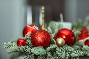 a composition with a candle, red and gold ornaments. The concept of Christmas and New Year, interior details, selective emphasis