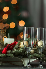 festive table on the background of a fir tree with a bokeh christmas and New Year's concept, interior details, selective focus