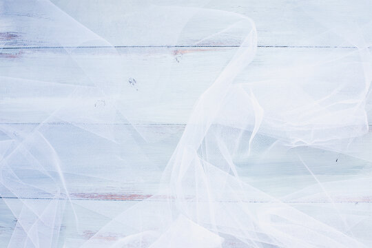 White Tulle over a teal blue background.  Table top view with free space for text.