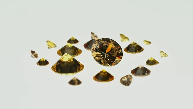 A group of Golden diamonds arranged in a row in front of white diamonds on a white background..Yellow heart diamond put on white background..video 4k.high quality video 4K raw blue stones background..