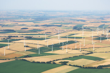 Aerial view of wind turbines farm in Saxony-Anhalt, Germany. Wind power plant and farmland in...