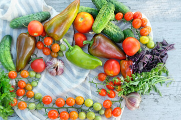 set of fresh ripe vegetables and towel on wooden table. organic Food background. harvesting concept. raw vegetables assorted for healthy vitamin food, diet. template for design. top view. copy space