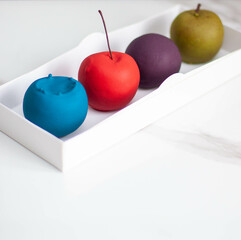 Modern realistic fruit pastries made of chocolate and mousse. Red apple, green apple, blueberry and passion fruit for cafe or restaurant