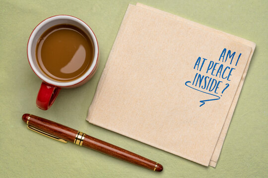 Am I at peace inside? Self reflection question on a napkin with coffee. Mindfulness and personal development concept.