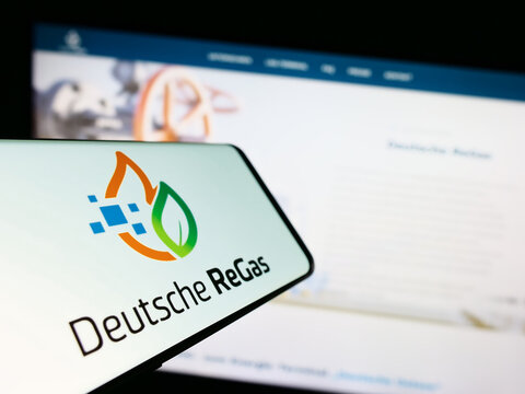 Stuttgart, Germany - 08-20-2023: Mobile phone with logo of German company Deutsche ReGas GmbH Co. KGaA on screen in front of website. Focus on center-left of phone display.