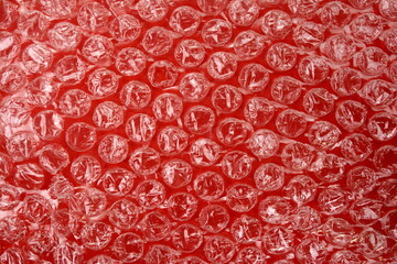 Red bubble plastic wrap surface. plastic with air balls on the surface used to pack glassware or electronics or sensitive items
