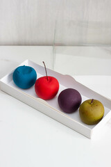 Modern realistic fruit pastries made of chocolate and mousse. Red apple, green apple, blueberry and passion fruit for cafe or restaurant