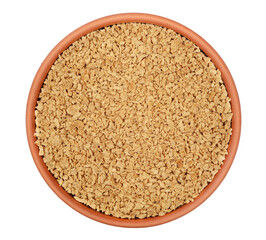 Soy flakes in clay pot isolated on white, top view 