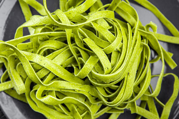 green pasta raw tagliatelle color basil vegetable food meal food snack on the table copy space food background rustic top view