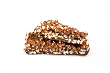 Chunks of milk chocolate with puffed rice isolated on white background. Rice chocolate studio isolated. 
