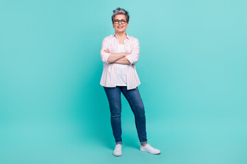 Fototapeta na wymiar Full length portrait of attractive cheerful grey hair pensioner worker woman hold arms crossed isolated turquoise color background