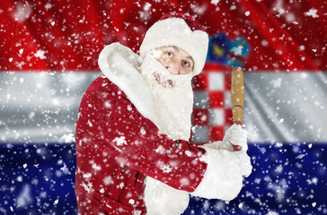 Santa Claus aggressively threatens with a bat against the backdrop of falling snow and the flag of Croatia