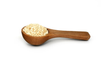 Sesame seeds in a wooden spoon isolated on white background