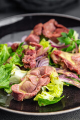 salad chicken stomach offal green lettuce, onion chicken meat offal vegetable meal food snack on the table copy space food background rustic top view