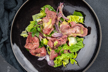 salad chicken stomach offal green lettuce, onion chicken meat offal vegetable meal food snack on the table copy space food background rustic top view