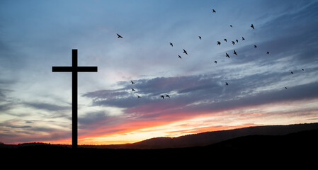 Christian cross on hill outdoors at sunrise. Resurrection of Jesus. Concept photo.