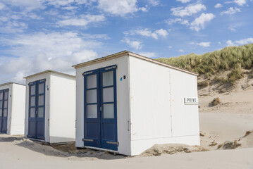 Obraz na płótnie Canvas Texel white beach storage huts next to the dunes
