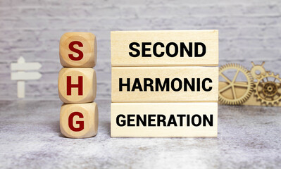 SHG - Second Harmonic Generation acronym text on notepad, abbreviation concept background.