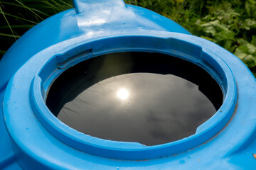 water collection tank under a roof with a drain. Rain water harvesting architecture