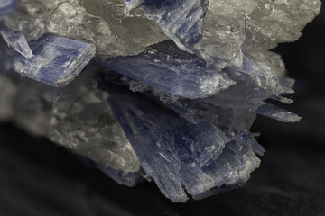 Striking blue kyanite crystal specimen showcased against a dark backdrop, capturing its mesmerizing allure