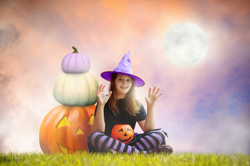 Child and on giant pumpkin lantern on Halloween