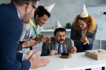 Businessman celebrate his birthday with friends at office - Powered by Adobe