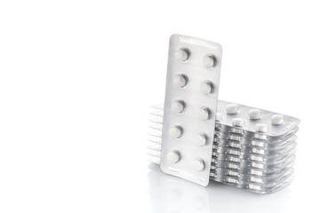 Pile of tablets in blister packaging. Pharmaceutical industry. Pharmacy products. Health care . New blister with pills isolated on a white background.