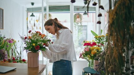 Busy florist make bouquet in flower shop workplace. Small business owner work.