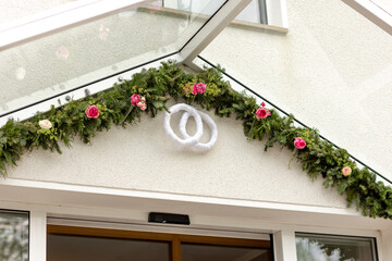 traditional German wedding decoration with rings and flower chain above the entrance