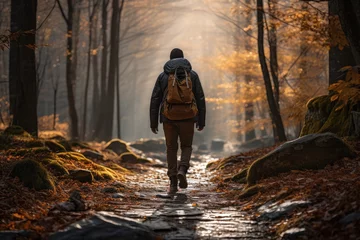 Fotobehang Bosweg Man hiking on a trail covered in a blanket of fallen leaves - Autumn Adventure - AI Generated