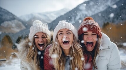 Three happy adult girls are having fun and throws first snow on background of mountains. Travel in winter time concept
