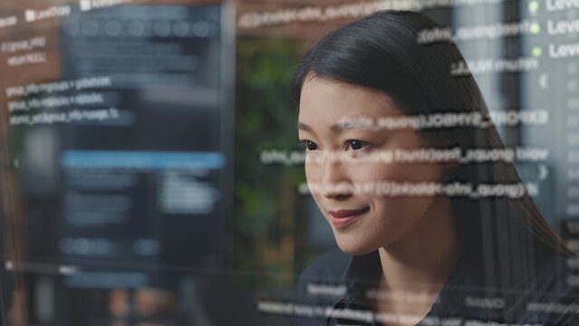 Computer scientist using AR technology to visualize script, writing code on computer screen while in office using JavaScript programming language. Specialist working on fixing company servers errors