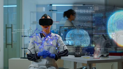 Scientific expert in laboratory wearing VR headset, using advanced equipment and wired sensors to...