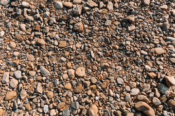 Sea stones in the sea water. Pebbles under water. The view from the top. Nautical background. Clean sea water. Transparent sea. Constância, Portugal 