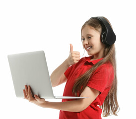 Little girl in headphones with laptop video chatting on white background