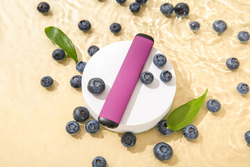 Decorative podium with electronic cigarette and blueberry in water on beige background