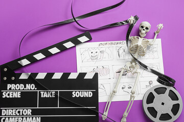 Clapperboard with film reel, storyboard and skeleton on purple background. Halloween celebration