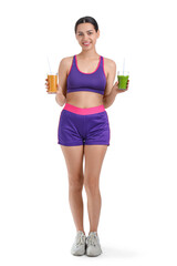 Fototapeta na wymiar Sporty young woman with glasses of healthy smoothie on white background