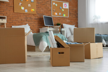 Cardboard boxes in dorm room on moving day - obrazy, fototapety, plakaty