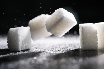 Close up of white cube sugar on black background