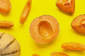 Pieces of sweet melon on yellow background