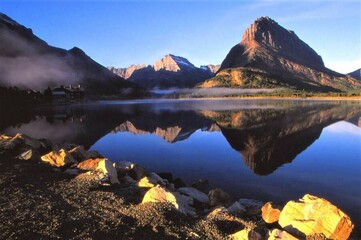 Swiftcurrent Lake - Glacier NP - MT - A mirror-like blue lake reflects the buttes on the far shore....