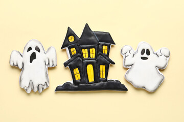 Tasty cookies in shape of ghost and house for Halloween celebration on beige background