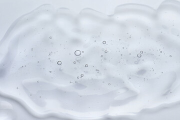 Sample of cosmetic oil on white background, closeup