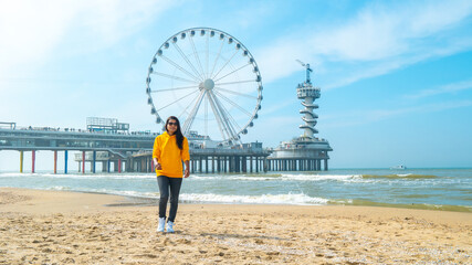 women on the beach of Scheveningen Netherlands during Spring, The Ferris Wheel at The Pier at Scheveningen in the Netherlands © Fokke Baarssen