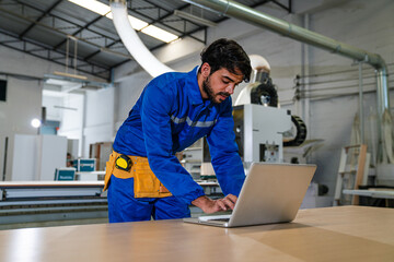Naklejka na ściany i meble engineers and technician using laptop checking and repair pressing metal machine at factory, Machine maintenance technician operation concept.