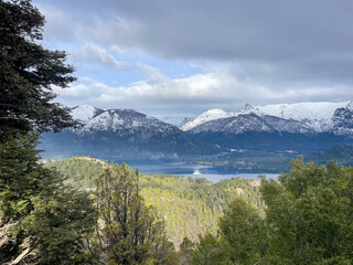 Beautiful range of snowy mountains and a lake with blue sky above in Bariloche Argentina, amazing...