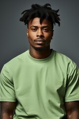 Fototapeta premium An attractive African American man wearing a green tee shirt with plain background. Generative AI.