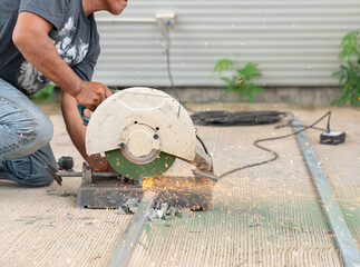 Worker cutting steel bars with Industry electric fiber.